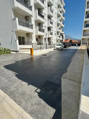 a parking lot in front of a large apartment building at Deluxe Apartment with Balcony and Sea View in Bar