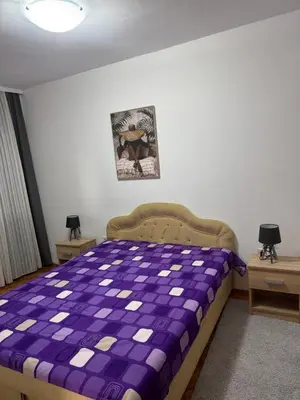 a bedroom with a purple bed with two night stands at Sweet house in Podgorica