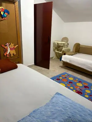 a bedroom with a bed and a door and a rug at Sweet house in Podgorica