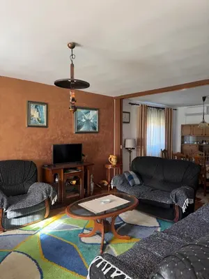 a living room with two couches and a tv at Sweet house in Podgorica