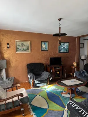 a living room with a couch and chairs and a tv at Sweet house in Podgorica
