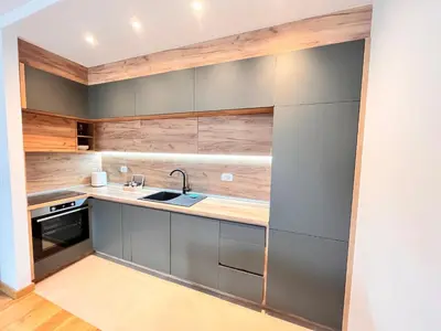 a kitchen with gray cabinets and a sink at New City Luxury Apartments in Podgorica