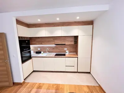 a kitchen with white cabinets and a sink at New City Luxury Apartments in Podgorica