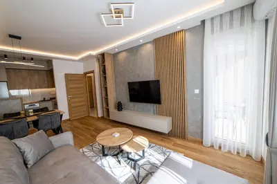 a living room with a couch and a table at New City Luxury Apartments in Podgorica