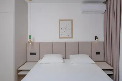 a bed with two pillows on it in a room at Bliss Apartments in Sutomore