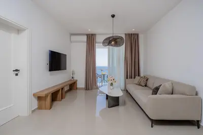 a living room with a couch and a tv at Bliss Apartments in Sutomore