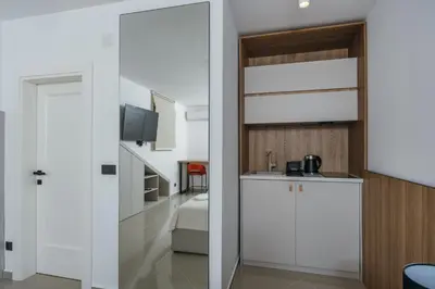 a room with a sliding door leading to a bedroom at Bliss Apartments in Sutomore
