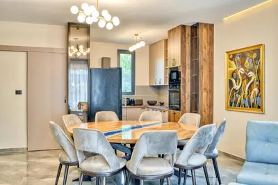 a kitchen and dining room with a wooden table and chairs at VILLA Amfora in Budva