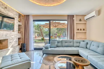 a living room with a blue couch and a fireplace at VILLA Amfora in Budva