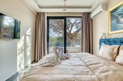 a bedroom with a large bed with a large window at VILLA Amfora in Budva
