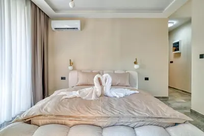 a bedroom with a large bed with towels on it at VILLA Amfora in Budva