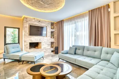 a living room with a couch and a fireplace at VILLA Amfora in Budva