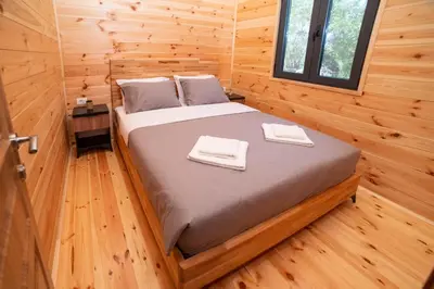 a bedroom with a bed in a log cabin at River house - Esperanza in Ulcinj