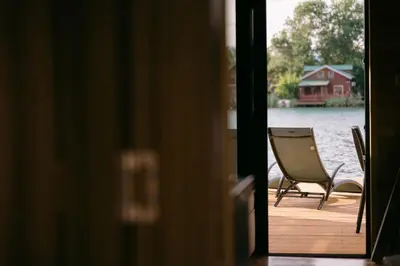 a chair sitting on a dock next to the water at River house - Esperanza in Ulcinj