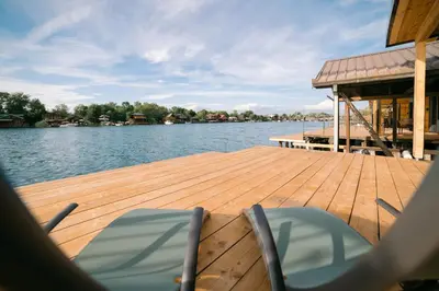 a wooden dock with chairs on top of the water at River house - Esperanza in Ulcinj
