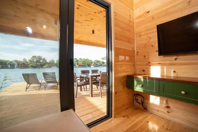 a cabin with a deck with a table and chairs at River house - Esperanza in Ulcinj