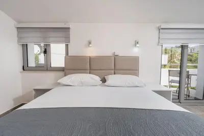 a bedroom with a large bed with two pillows at Sunset Marina in Bar