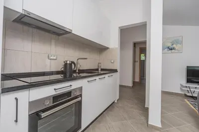 a kitchen with a sink and a stove at Sunset Marina in Bar