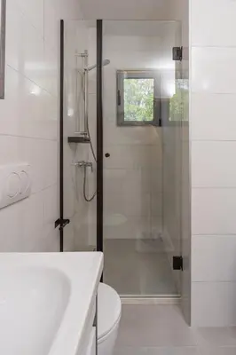 a bathroom with a shower and a toilet and a sink at Sunset Marina in Bar