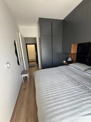 a bedroom with a large bed and a phone on the wall at Apollo 2 in Ulcinj
