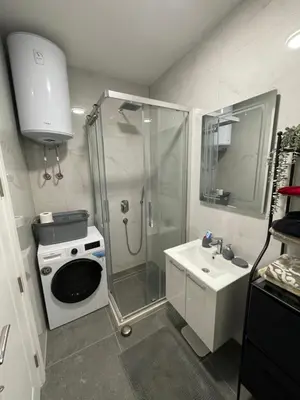 a bathroom with a shower and a toilet and a sink at Apollo 2 in Ulcinj