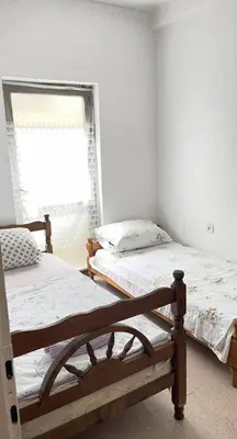 two beds in a room with a window at Hostel Flash in Ulcinj