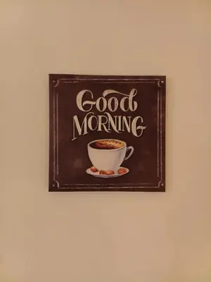 a chalkboard with a cup of coffee on a wall at Hostel Flash in Ulcinj
