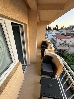 a balcony of a building with chairs on it at Apartment Saint Tropez Budva, Privatna garaža in Budva