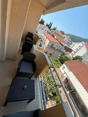 a balcony of a building with chairs and buildings at Apartment Saint Tropez Budva, Privatna garaža in Budva