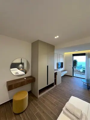 a large living room with a table and a chair at Villa Marmo in Ulcinj