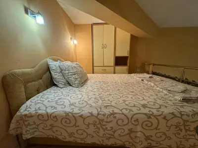 a bedroom with a large bed and a cabinet at Budva Center Studio in Budva