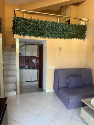 a living room with a couch and a kitchen at Budva Center Studio in Budva