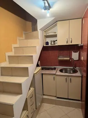 a kitchen with a staircase leading up to a sink at Budva Center Studio in Budva
