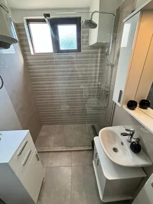 a bathroom with a shower and a sink at Apartman Ela Podgorica in Podgorica