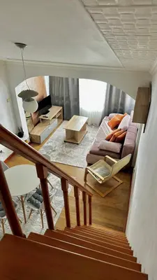 a living room with a couch and a table at Loft apartment Kapisoda in Budva