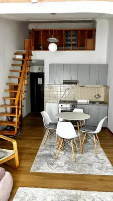 a kitchen and dining room with a table and chairs at Loft apartment Kapisoda in Budva