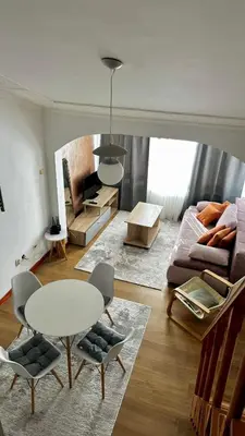 a living room with a table and a couch at Loft apartment Kapisoda in Budva