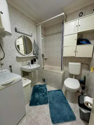 a bathroom with a toilet and a sink and a mirror at Loft apartment Kapisoda in Budva