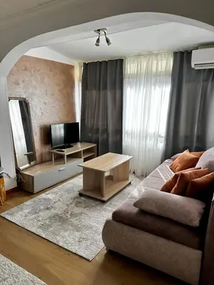 a living room with a couch and a mirror at Loft apartment Kapisoda in Budva