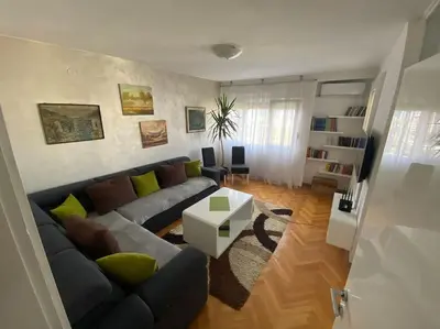 a living room with a couch and a table at Tea apartment in Podgorica
