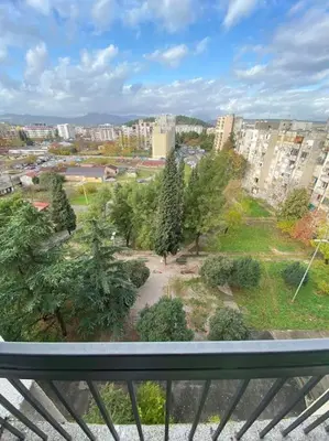 a view of a park with trees and buildings at Tea apartment in Podgorica
