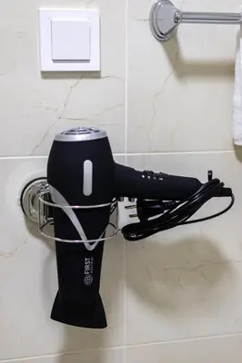 a hair dryer is hanging on a wall at Two bedroom apartment Mali princ in Budva