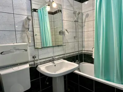 a bathroom with a sink and a mirror at Central 25 in Podgorica