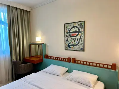 a bedroom with a bed and a picture on the wall at Central 25 in Podgorica