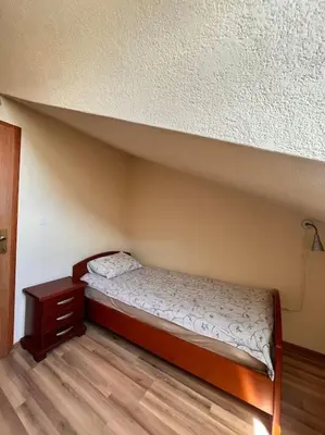 a small bed in a room with a bed frame at Apartment Marron Matou Budva in Budva