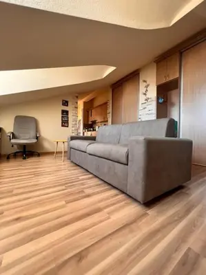 a living room with a couch and a chair at Apartment Marron Matou Budva in Budva