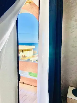 an open door with a view of the ocean at Karadag in Ulcinj