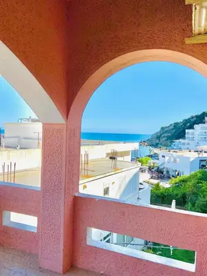 a balcony with a view of the ocean and buildings at Karadag in Ulcinj