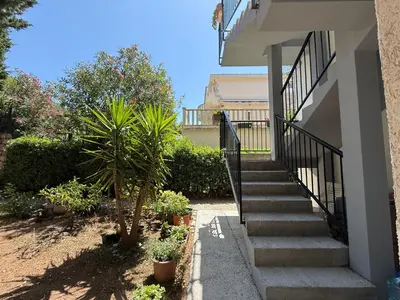a staircase leading up to a house with plants at Apartmani Mareta in Petrovac na Moru