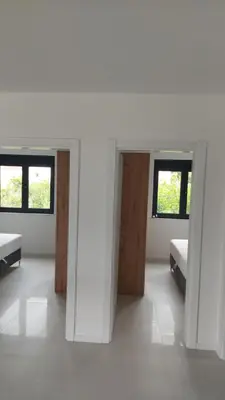a white room with two beds and two windows at Casa Aurelia in Gornji Štoj